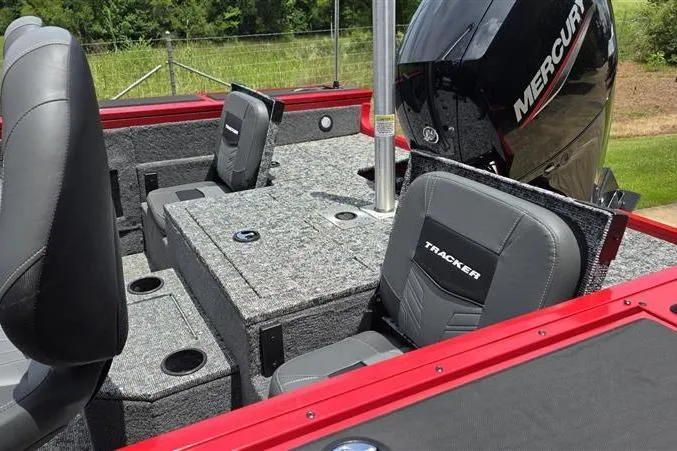 Slide: The Image of 2026 Tracker Targa V-18 Combo boat interior with Mercury engine, featuring gray seating and red accents. - 13
