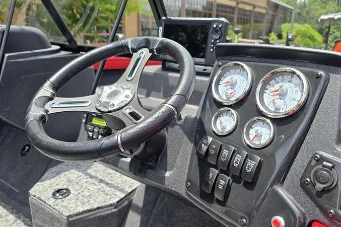 Slide: The Image of 2026 Tracker Targa V-18 Combo dashboard with steering wheel and gauges. - 11