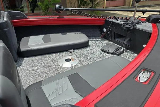 Slide: The Image of 2026 Tracker Targa V-18 Combo boat interior with red trim and seating area. - 8
