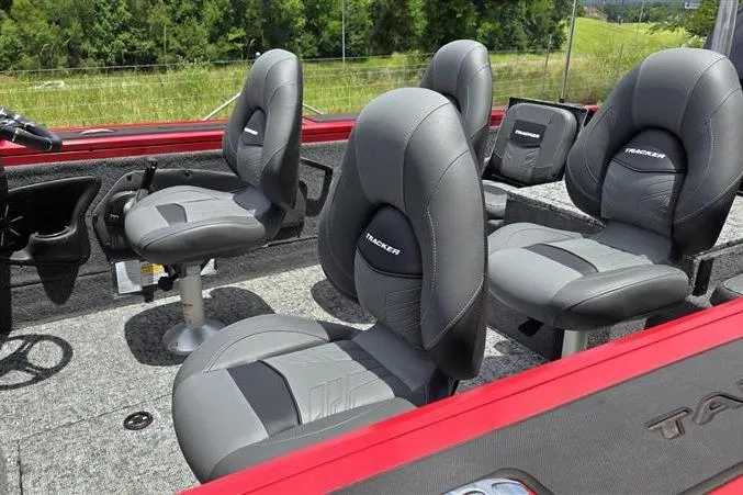 Slide: The Image of 2026 Tracker Targa V-18 Combo boat interior with gray seating and red accents. - 7