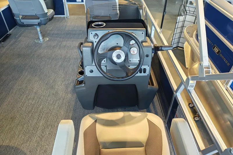 Slide: The Image of Interior view of 2026 Sun Tracker Bass Buggy 18 DLX pontoon boat steering console. - 16