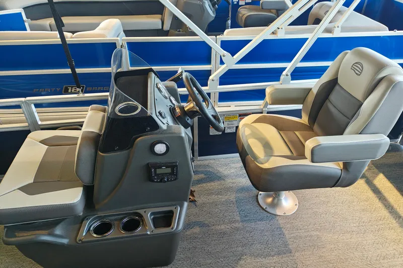 Slide: The Image of 2026 Sun Tracker Bass Buggy 18 DLX interior with steering console and seating. - 7