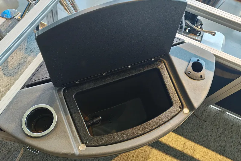 Slide: The Image of Open storage compartment on 2026 Sun Tracker Bass Buggy 18 DLX boat deck. - 12