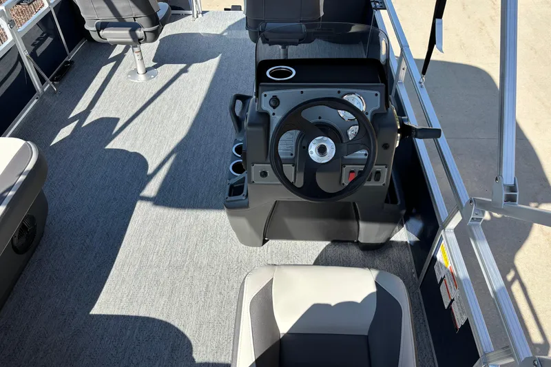 Slide: The Image of Interior view of 2026 Sun Tracker Bass Buggy 18 DLX pontoon boat cockpit. - 6