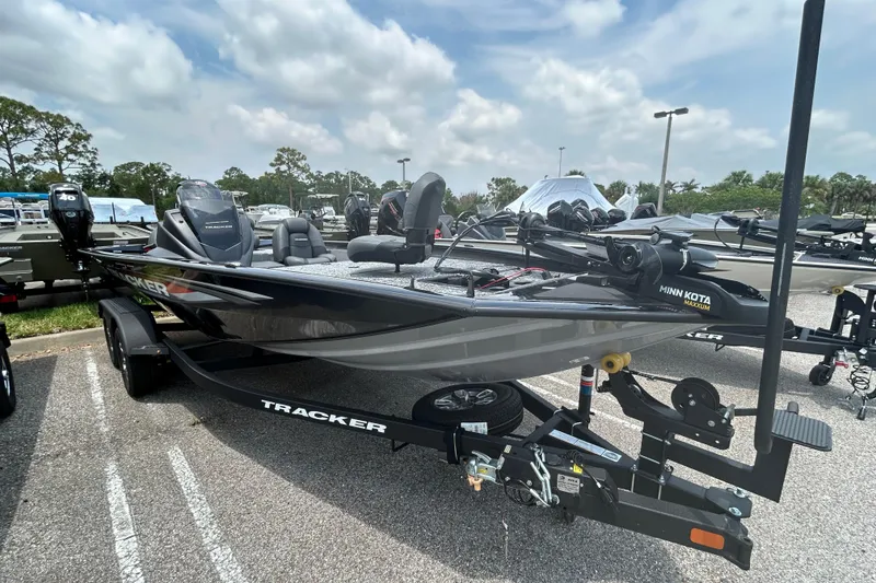 The Image of 2026 Tracker Pro Team 195 boat on trailer, parked outdoors under cloudy sky. - 0