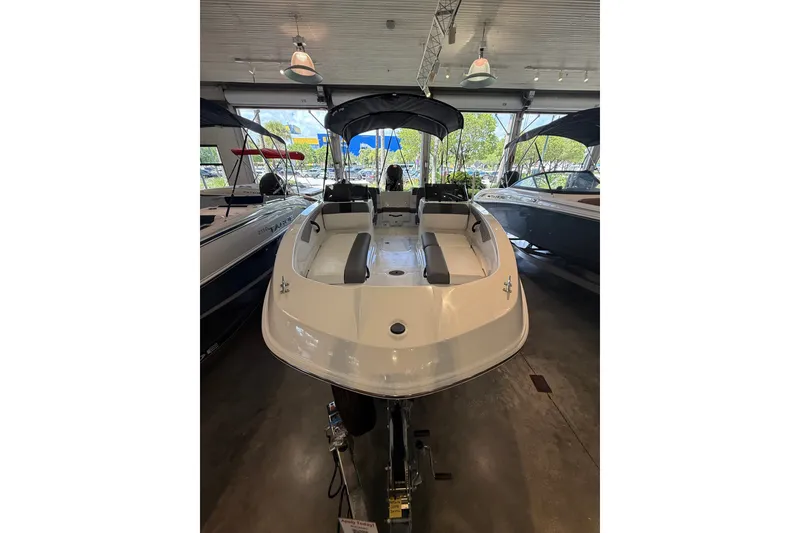 The Image of 2026 Tahoe T21 boat displayed in a showroom, featuring sleek design and modern amenities. - 0