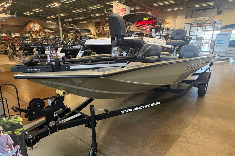 The Image of A 2026 Tracker Pro Team 175 Crappie Edition boat is displayed in a showroom. - 0