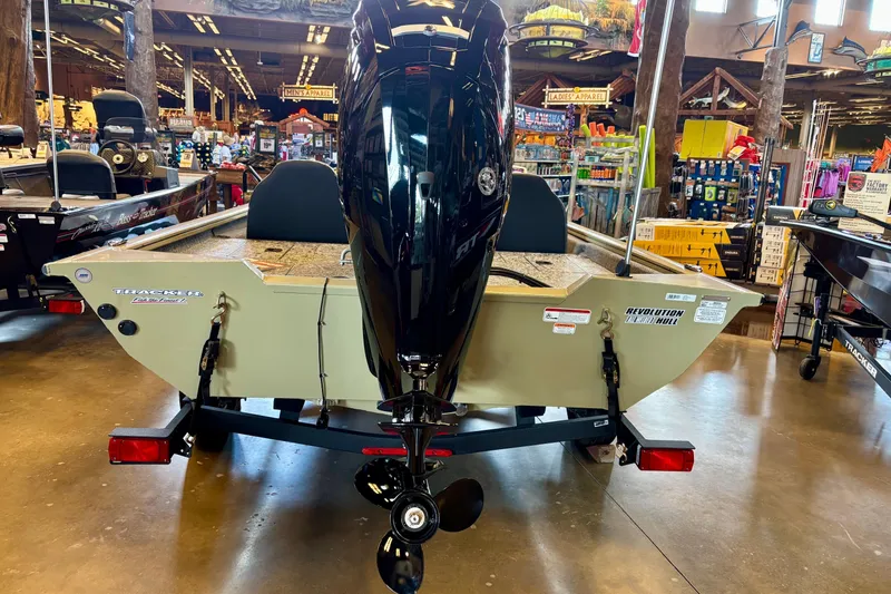 Slide: The Image of 2026 Tracker Pro Team 175 boat displayed indoors, featuring a powerful outboard motor. - 2