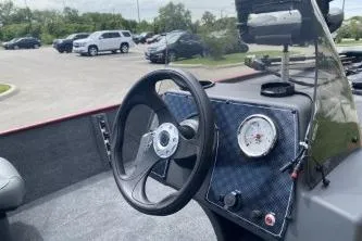 Slide: The Image of 2026 Tracker Bass Tracker Classic XL boat dashboard with steering wheel and gauge. - 4