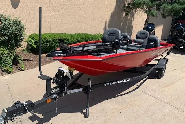 Slide: The Image of 2026 Tracker Pro Team 175 boat in red, parked on a trailer outdoors. - 16