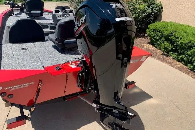 Slide: The Image of 2026 Tracker Pro Team 175 boat with Mercury outboard motor, parked on a driveway. - 17