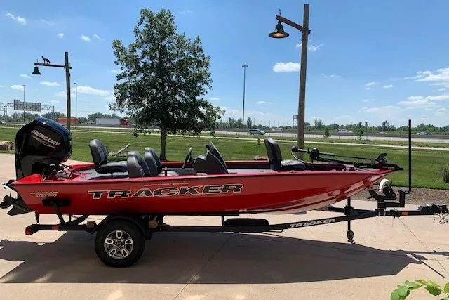 Slide: The Image of 2026 Tracker Pro Team 175 boat in red, parked outdoors on a trailer. - 12