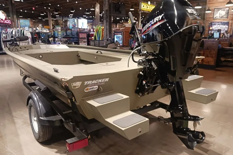 The Image of 2026 Tracker Grizzly 1654 T Sportsman boat with Mercury engine in showroom. - 0