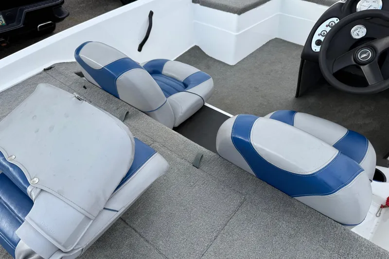 Slide: The Image of 2005 Nitro 700 LX SC boat interior with blue and gray seats and steering console. - 2