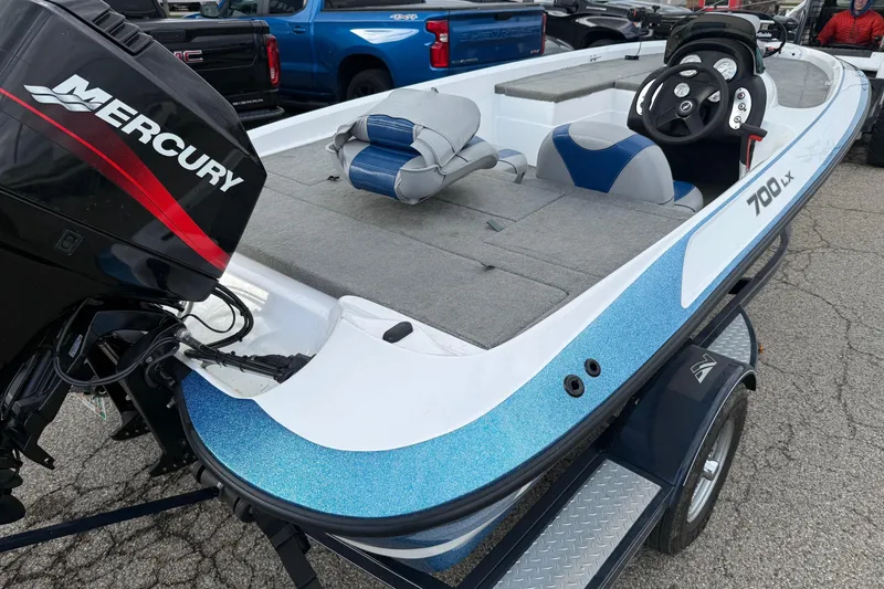 Slide: The Image of 2005 Nitro 700 LX SC boat with Mercury engine, parked on a trailer. - 6