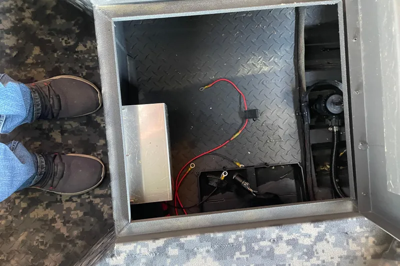 Slide: The Image of Interior view of 2026 Reaper Boats 653 Timber Reaper showing wiring and storage compartment. - 14