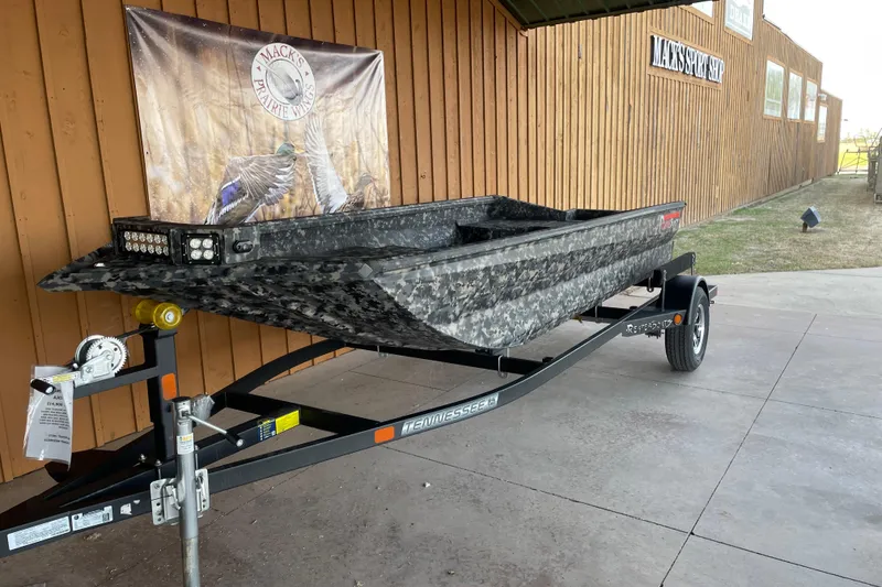 Slide: The Image of 2026 Reaper Boats 653 Timber Reaper on trailer, displayed outdoors. - 2