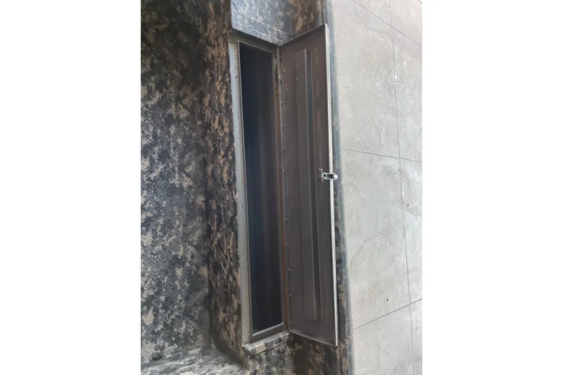 Slide: The Image of Camouflage-patterned compartment door on 2026 Reaper Boats 653 Timber Reaper. - 4