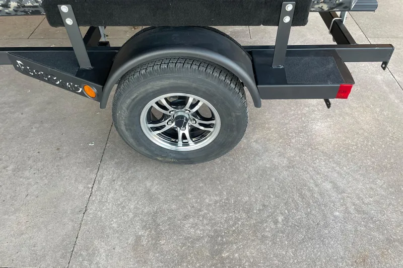 Slide: The Image of Trailer wheel of 2026 Reaper Boats 653 Timber Reaper on concrete surface. - 5