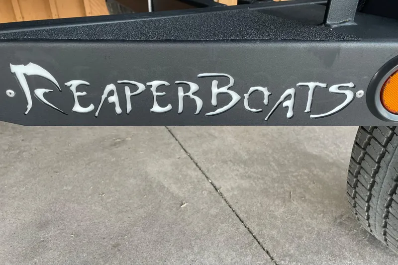 Slide: The Image of Reaper Boats logo on 2026 653 Timber Reaper trailer, featuring bold lettering and design. - 6