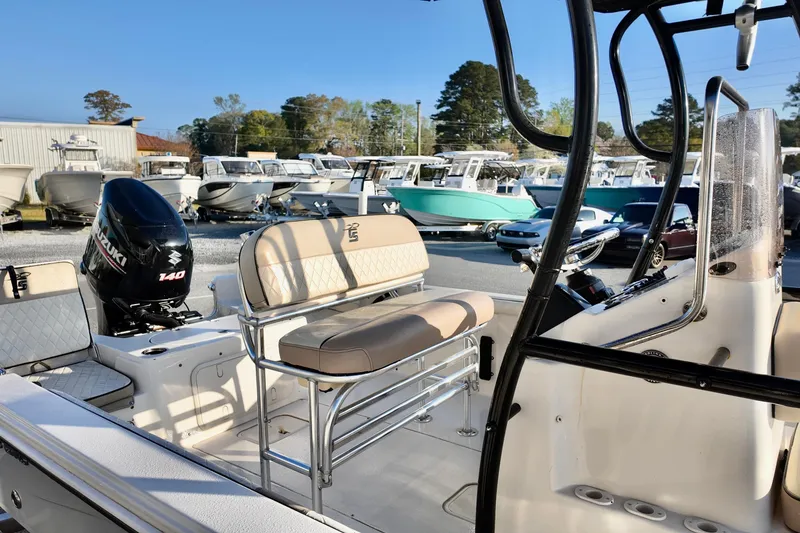 Slide: The Image of 2020 Carolina Skiff 21 LS boat with Suzuki 140 engine, parked among other boats. - 11