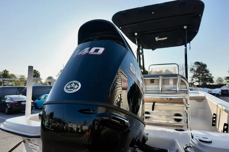 Slide: The Image of 2020 Carolina Skiff 21 LS boat with Suzuki 140 outboard motor, parked outdoors. - 3