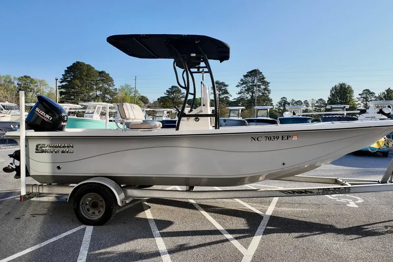 Slide: The Image of 2020 Carolina Skiff 21 LS boat on trailer, parked in marina lot. - 4