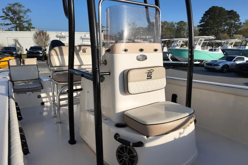 Slide: The Image of 2020 Carolina Skiff 21 LS boat interior with seating and console, parked outdoors. - 8
