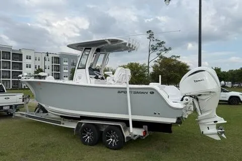 Slide: The Image of 2024 Sportsman Heritage 231 Center Console boat on trailer, parked outdoors. - 1
