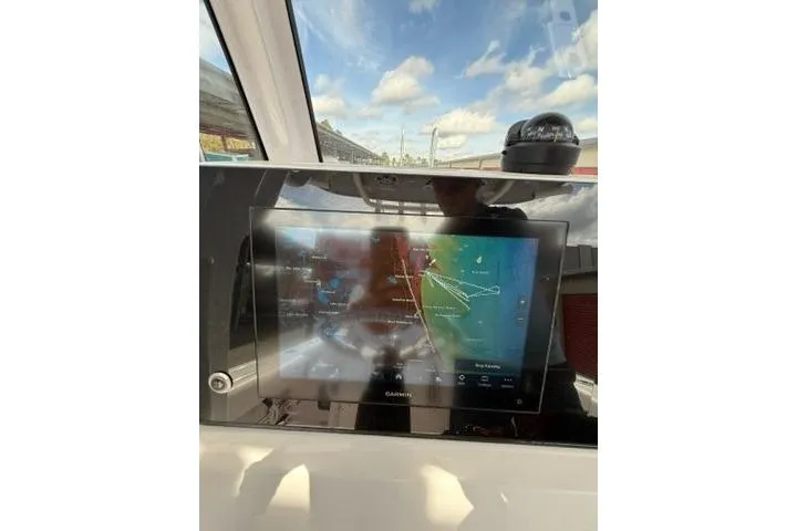 Slide: The Image of 2024 Sportsman Heritage 231 Center Console with Garmin navigation display. - 12