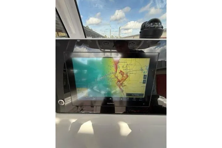 Slide: The Image of 2024 Sportsman Heritage 231 Center Console with Garmin navigation display. - 13