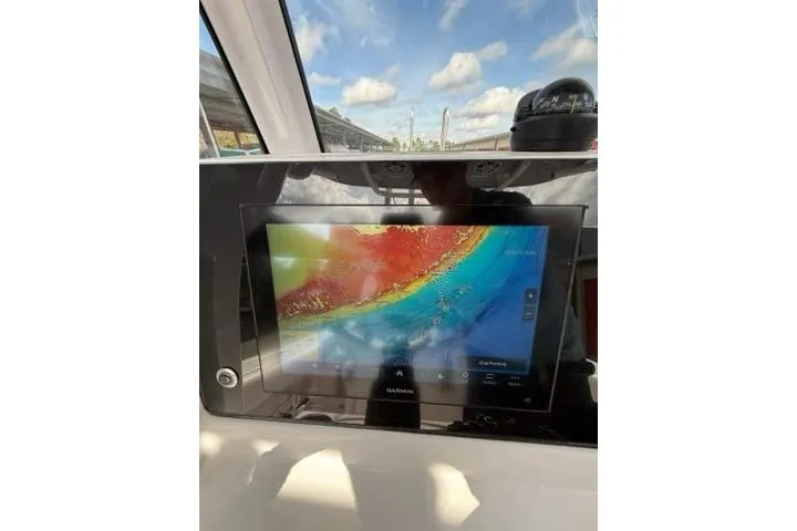 Slide: The Image of 2024 Sportsman Heritage 231 Center Console with Garmin navigation display. - 14