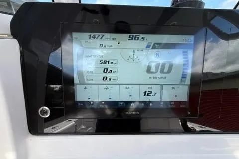 Slide: The Image of 2024 Sportsman Heritage 231 Center Console dashboard with Garmin display showing navigation data. - 16