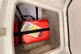 Slide: The Image of Storage compartment in 2024 Sportsman Heritage 231 Center Console boat with safety gear. - 19