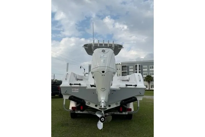 Slide: The Image of 2024 Sportsman Heritage 231 Center Console boat, rear view, parked on grass. - 2