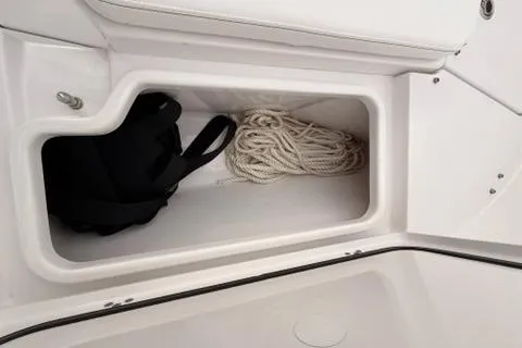 Slide: The Image of 2024 Sportsman Heritage 231 Center Console storage compartment with rope and bag. - 22
