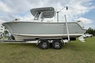 Slide: The Image of 2024 Sportsman Heritage 231 Center Console boat on trailer, parked on grass. - 4