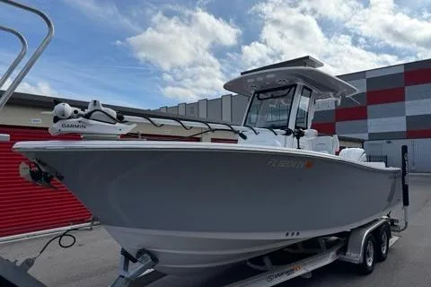 Slide: The Image of 2024 Sportsman Heritage 231 Center Console boat on trailer, parked outdoors. - 9