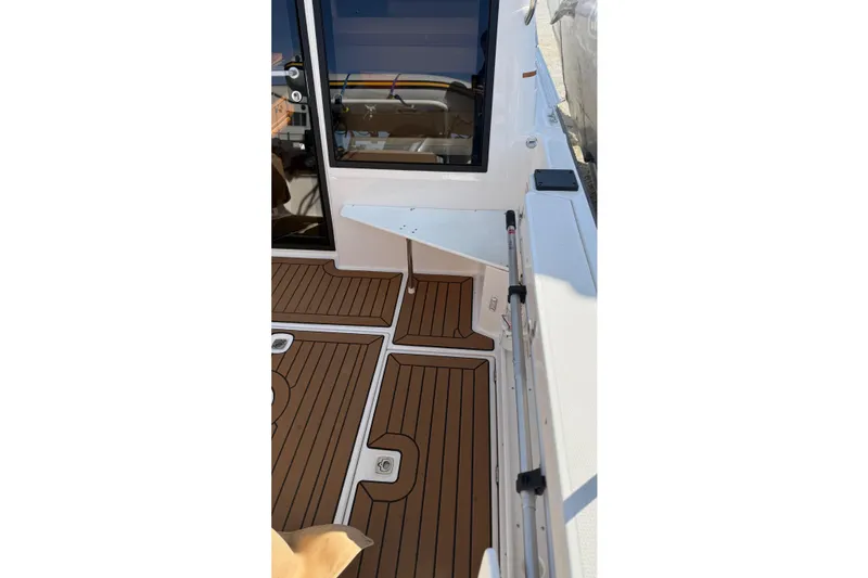 Slide: The Image of 2024 Ranger Tugs R-27 boat deck with wood finish and modern design elements. - 11