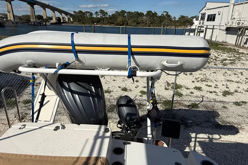 Slide: The Image of 2024 Ranger Tugs R-27 with inflatable boat and outboard motor, dockside view. - 13