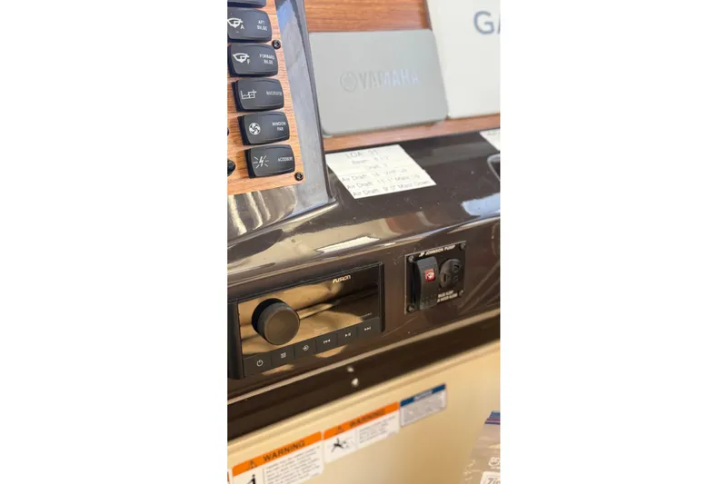 Slide: The Image of Control panel of 2024 Ranger Tugs R-27 boat with switches and audio system. - 17