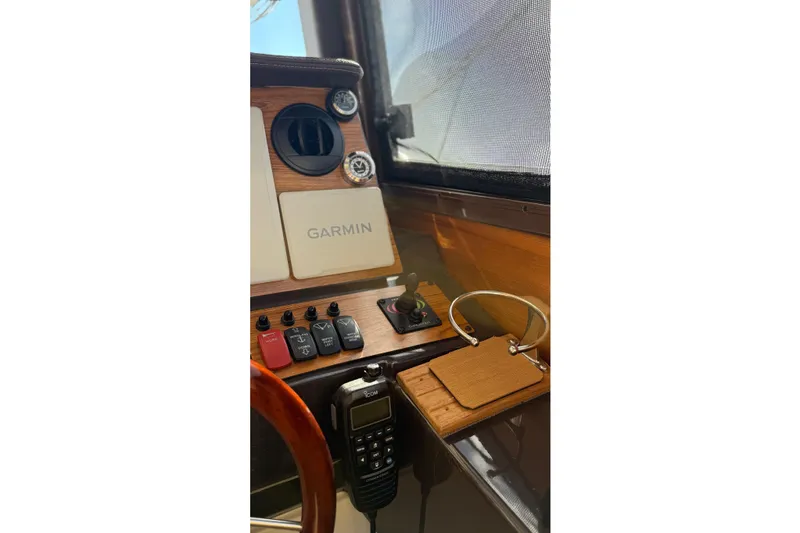 Slide: The Image of 2024 Ranger Tugs R-27 helm with Garmin navigation and control panel. - 18