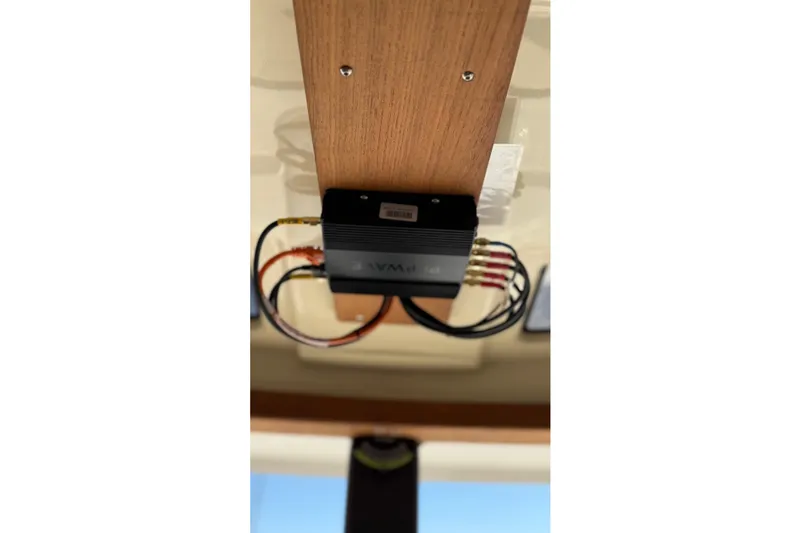 Slide: The Image of 2024 Ranger Tugs R-27 electronic component installation on wooden panel. - 20