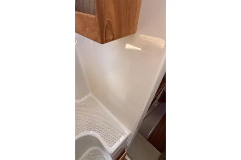 Slide: The Image of Interior detail of 2024 Ranger Tugs R-27 boat, featuring wood and fiberglass elements. - 21