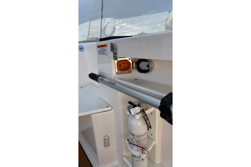 Slide: The Image of 2024 Ranger Tugs R-27 boat interior with safety equipment and utility connections. - 26