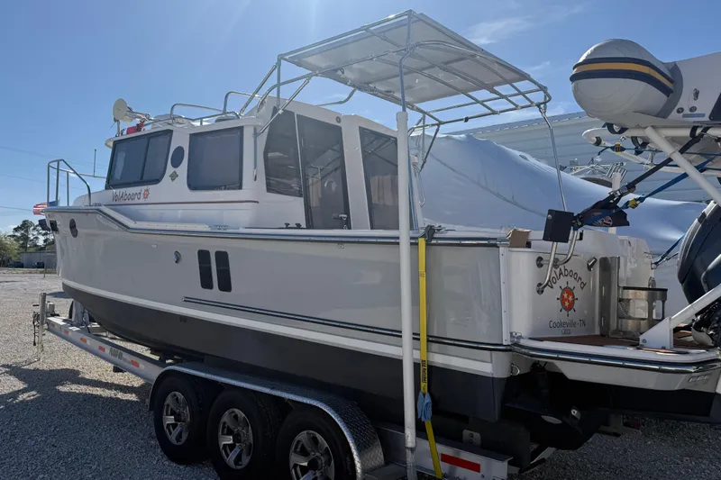 Slide: The Image of 2024 Ranger Tugs R-27 boat on trailer, side view, sunny day. - 4