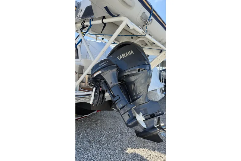 Slide: The Image of 2024 Ranger Tugs R-27 with Yamaha outboard motor, displayed on gravel surface. - 6