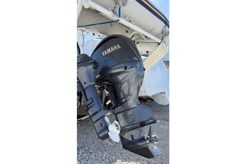 Slide: The Image of 2024 Ranger Tugs R-27 with Yamaha outboard motor, displayed on gravel surface. - 7