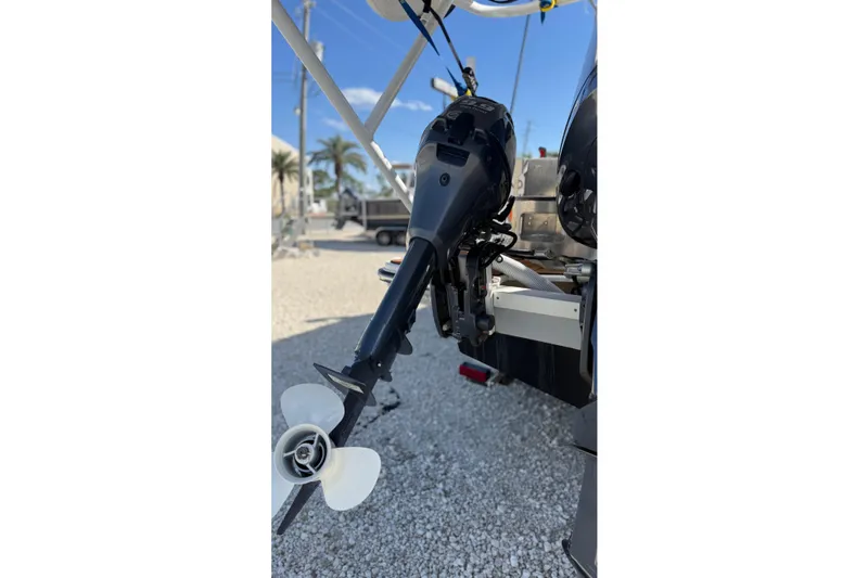 Slide: The Image of 2024 Ranger Tugs R-27 boat motor and propeller in a sunny outdoor setting. - 8