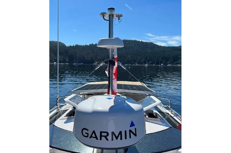 Slide: The Image of 2024 Ranger Tugs R-27 boat with Garmin equipment on a serene lake. - 9